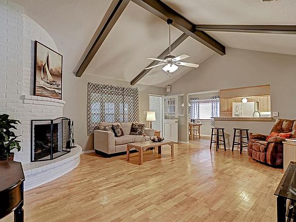 Living Room featuring Fire Place, high ceiling w/beams and hardwood floors