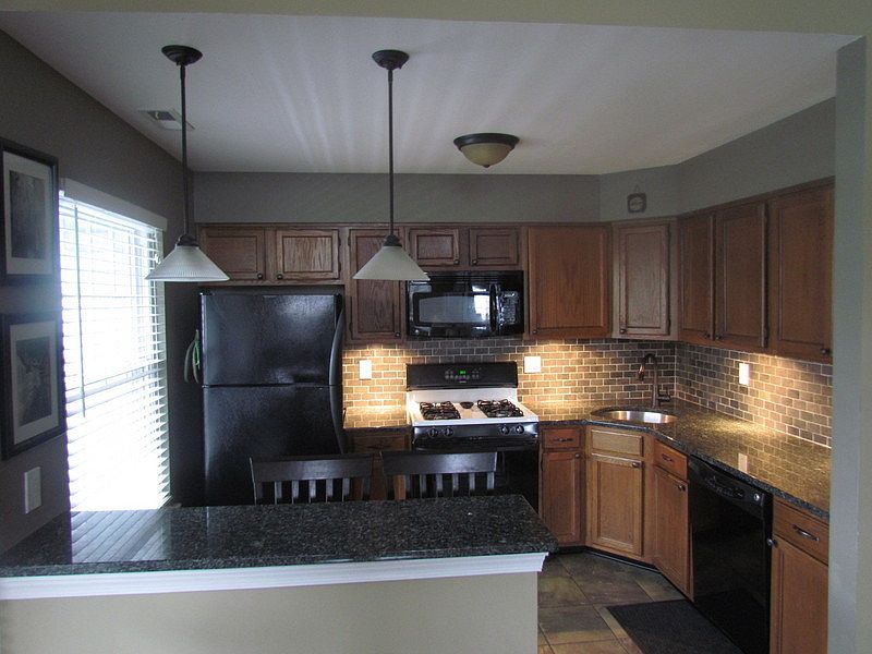 End unit with a wide porch. A dedicated parking space is directly in front