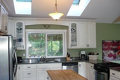 Updated kitchen with granite countertops and stainless appliances. Large pantry, skylights, and larg