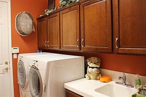Laundry room with deep sink and cabinets and custom cabinet hardware.