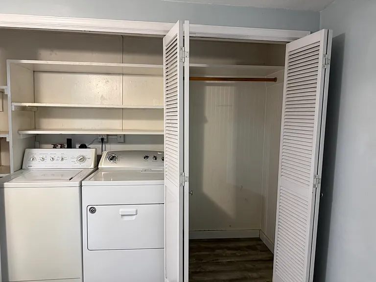 Utility closet. Large open space, shelves over washer and dryer.