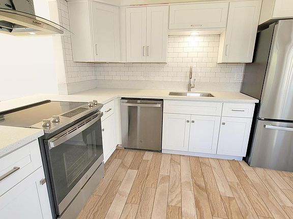 All New Stainless Steel Appliances, Gleaming Quartz Countertops and Subway Tile Backsplash