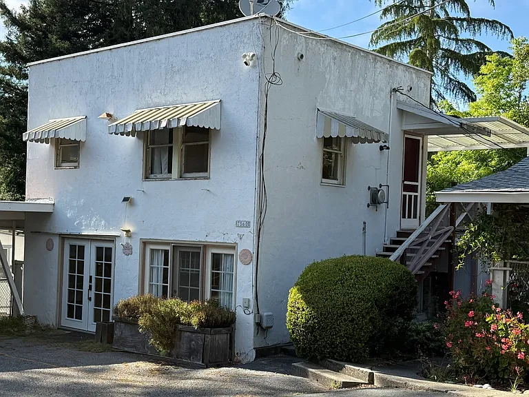 An exterior view of the Carriage House. This two-story home is for your exclusive use and has worked well for families with children as well as roommates. Your private laundry is downstairs in the utility room.