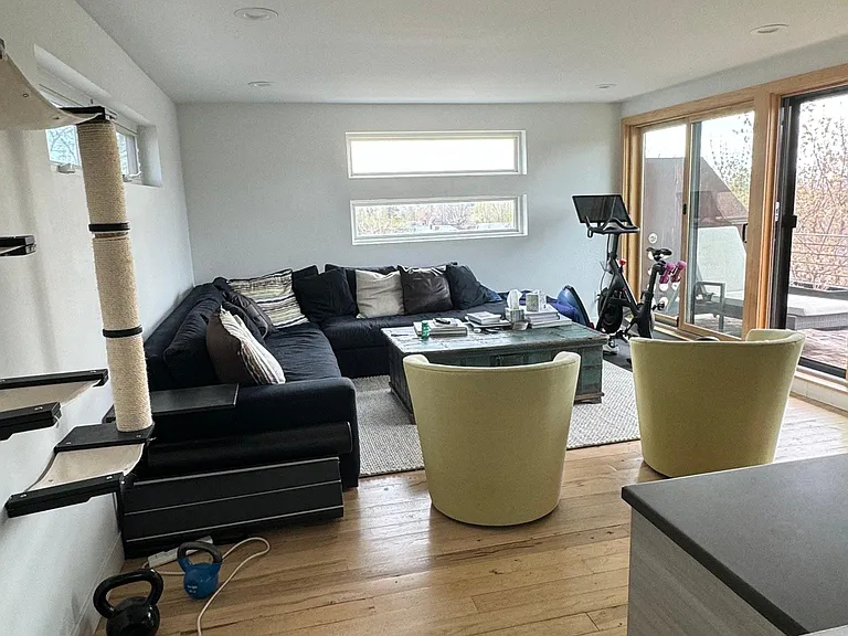 Third floor, spacious living room with bar area. Used as family room and gym with room to spare.