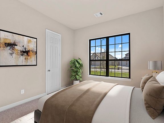 Perfect for family or guests, third bedroom with a walk-in closet and soft carpet underfoot.