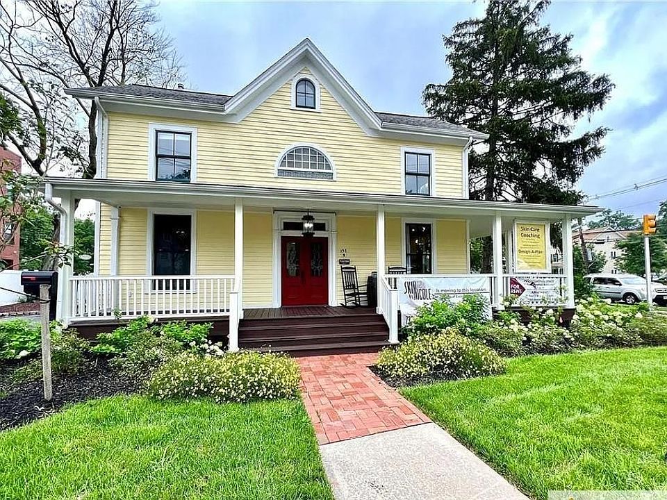 Front of house showing double red door entrance to entire second floor private apartment. Downstairs contains 2 quiet spa businesses.