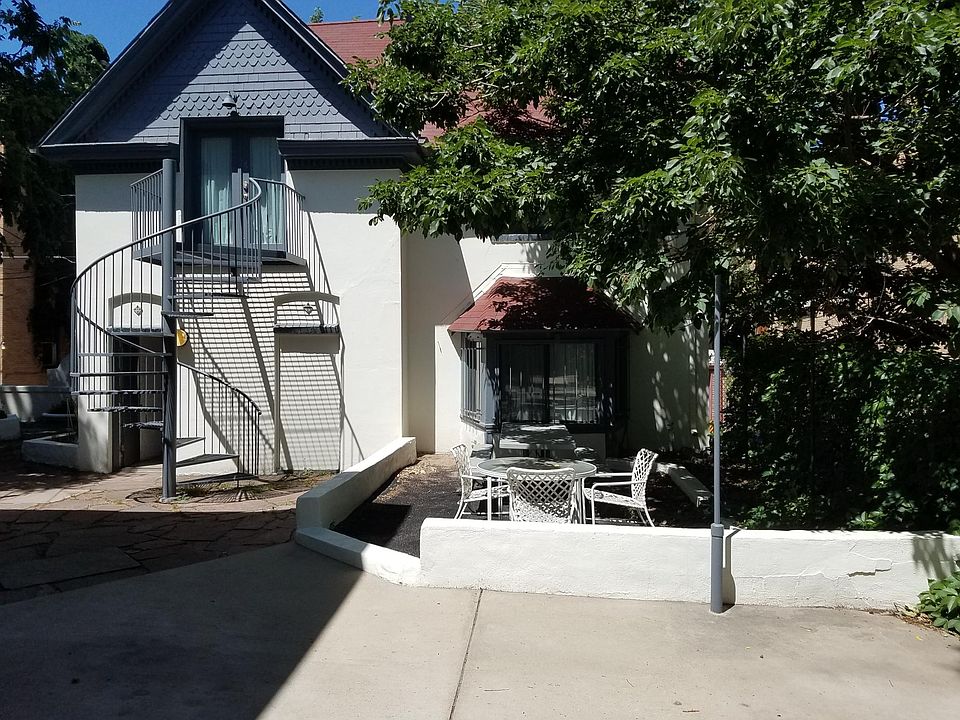 Carriage house is set back from the main street. Apartment #5 is accessed on the lower door left side of the photo.