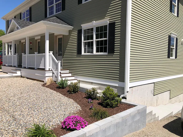 Landscaped and beautiful Front entrance with porch showing 4 units- 2 over 2