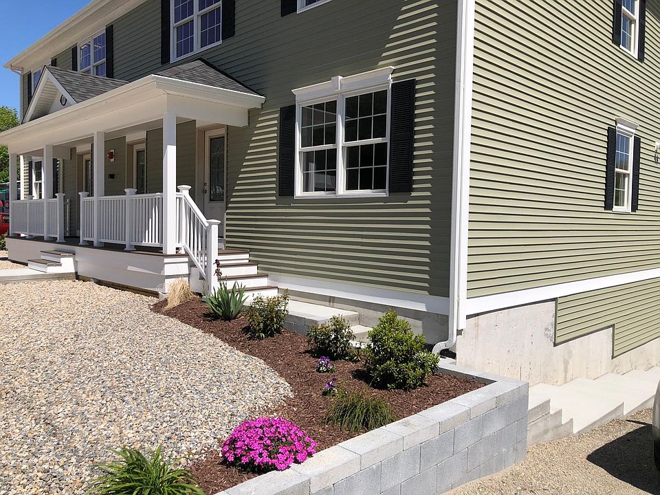Landscaped and beautiful Front entrance with porch showing 4 units- 2 over 2