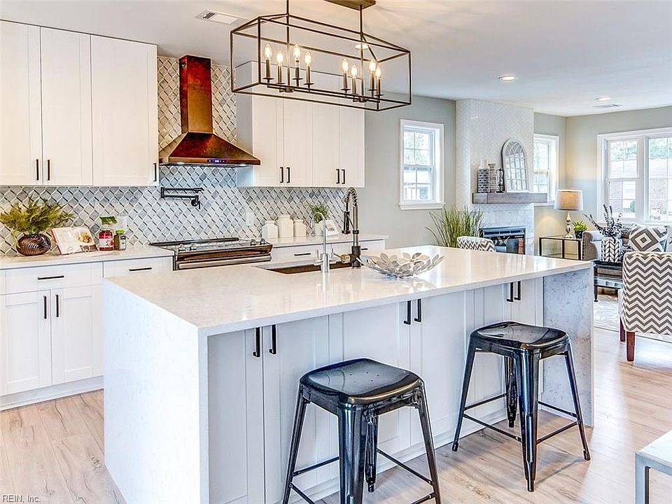 Stunning Kitchen with Quartz Countertops including Waterfall Counter Island and ample storage. Marble backslash and Instant Hot Water at Stove and Sink!