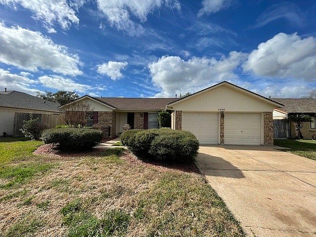 Front of home and large driveway