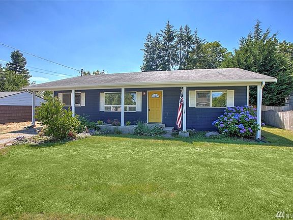This home has great curb appeal with the yellow door and covered front entry.