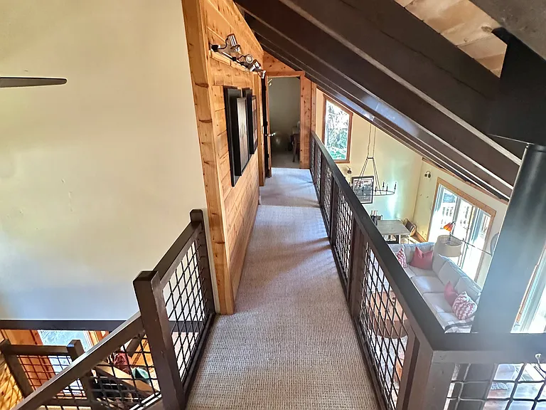 View down the open loft to the two bedrooms. Vantage point here is walking out of the upstairs bathroom.