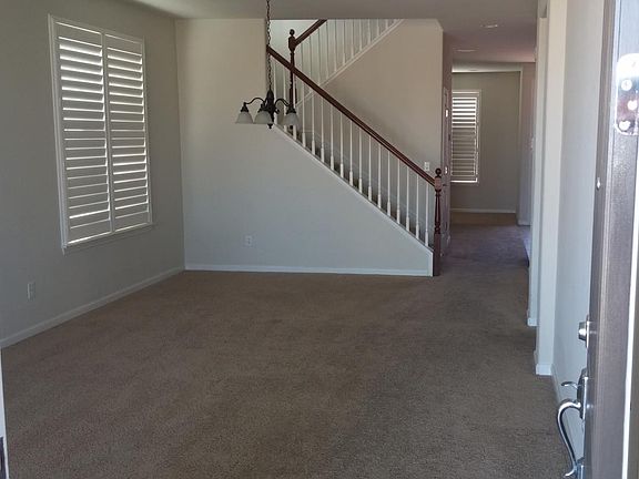 Walking into the house. Living room, stairs, hallway to righ