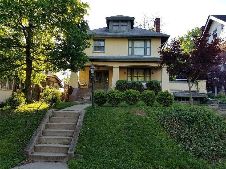 Nice front yard with a flat area for kids to play and a delightful front porch with a swing.