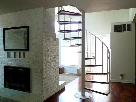 View back to front door. Gas fireplace is not operational. Hall and bedrooms are to the right.