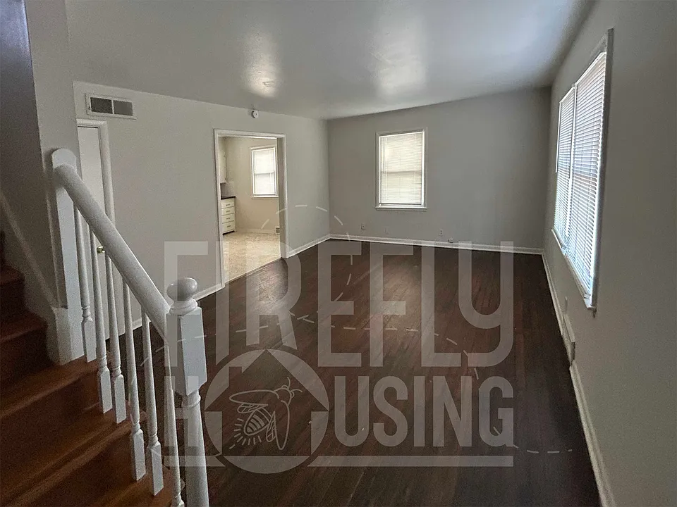 Living Room looking from Front Entry, hardwood floors and 3 windows with 1" vinyl mini blinds.
