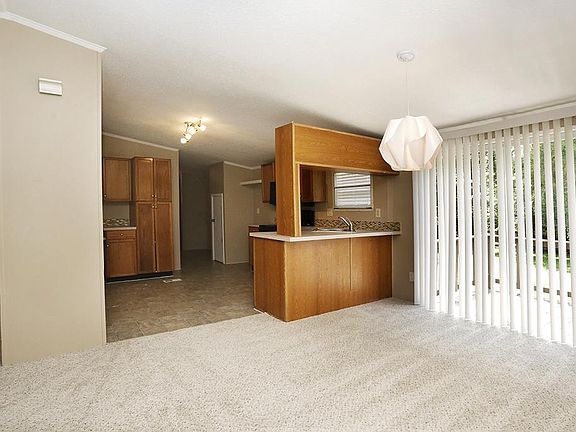 Breakfast area looking out onto back deck, with kitchen area left