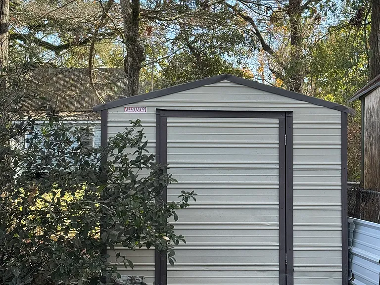 Good size back yard with storage building!