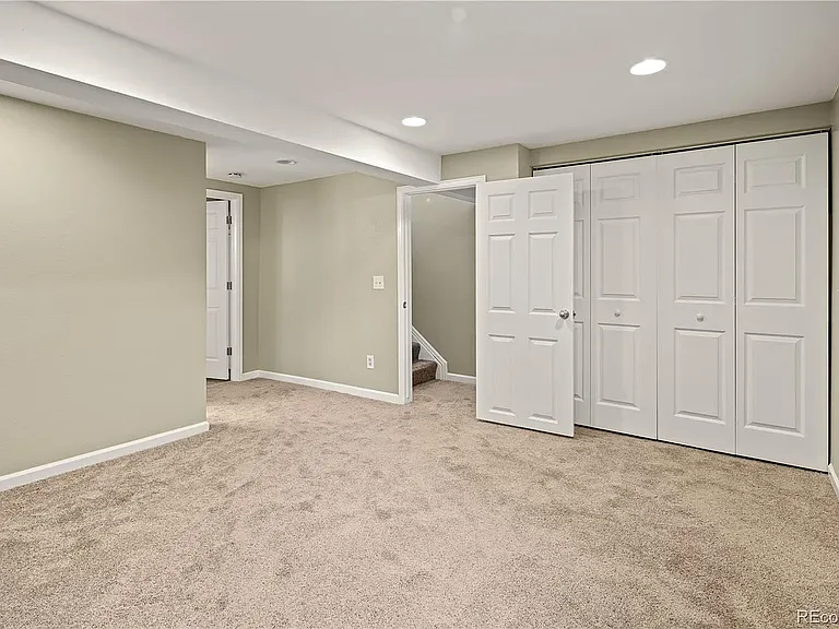 Downstairs bedroom with dual closet doors.