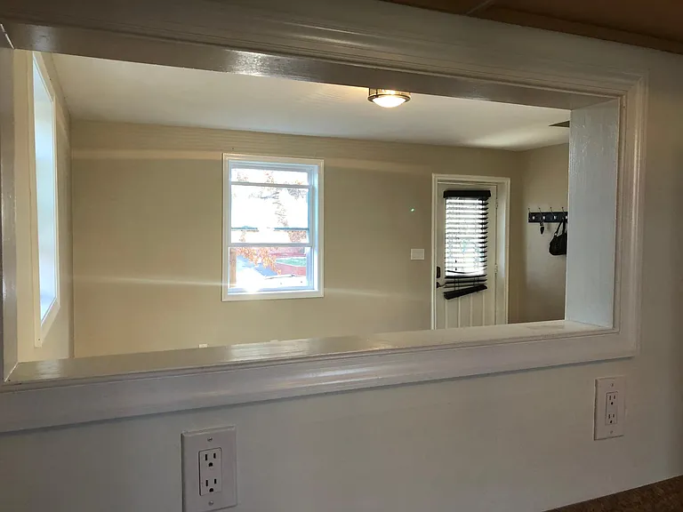 Window in Living room with view to kitchen