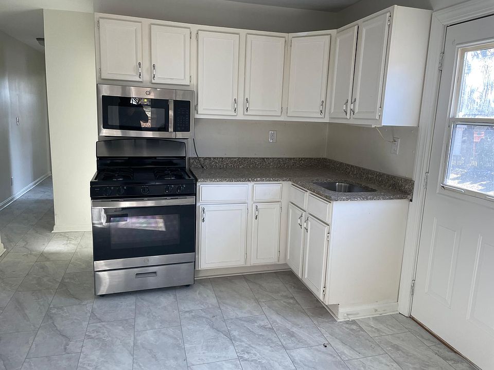 Unit A Kitchen. New floors throughout. Private side entrance on right. Granite Counters. Gas Stove.