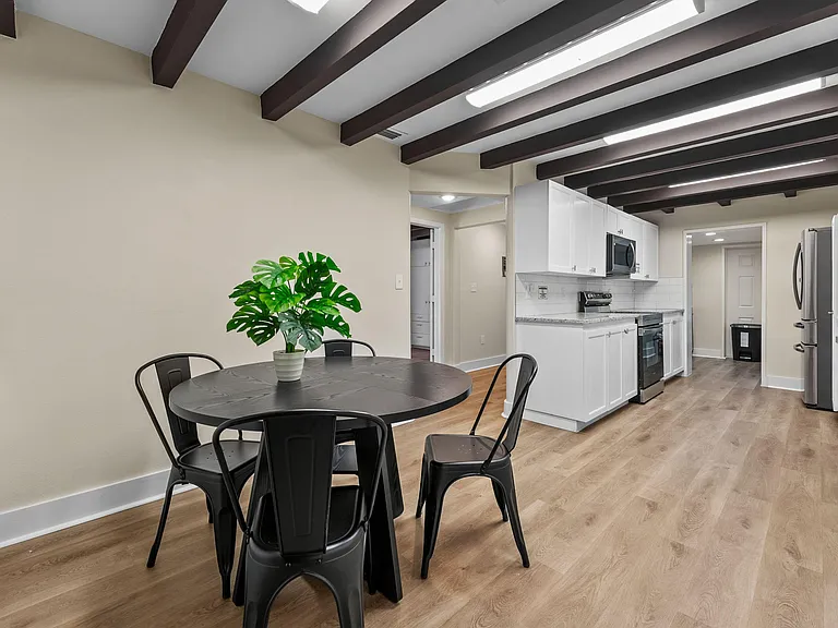 Open kitchen with ample white cabinetry, stainless appliances, and an adjacent dining area for everyday meals.