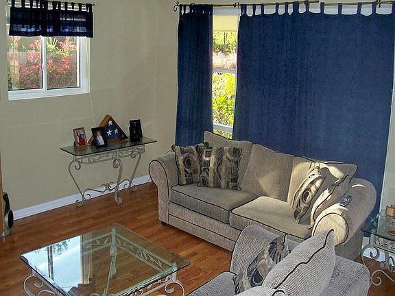 Living room with new wood laminate flooring.