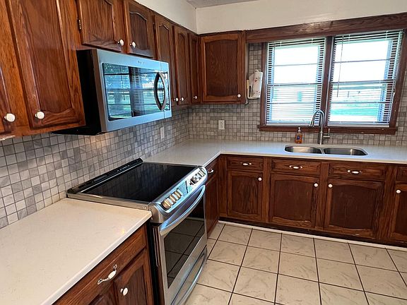Kitchen with new appliances (stove, microwave, dishwasher, two ice makers, refrigerator/freezer, garbage disposal