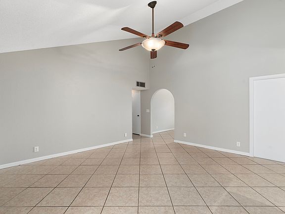 Family room with lofted ceiling off kitchen