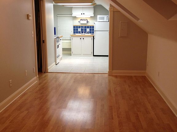 Living room. Skylights. Wood floors. Kitchen. Bedroom pocket door on left.