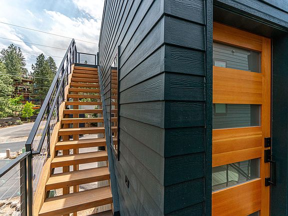 Entrance + stairs up to private roof deck with brand new BBQ + views