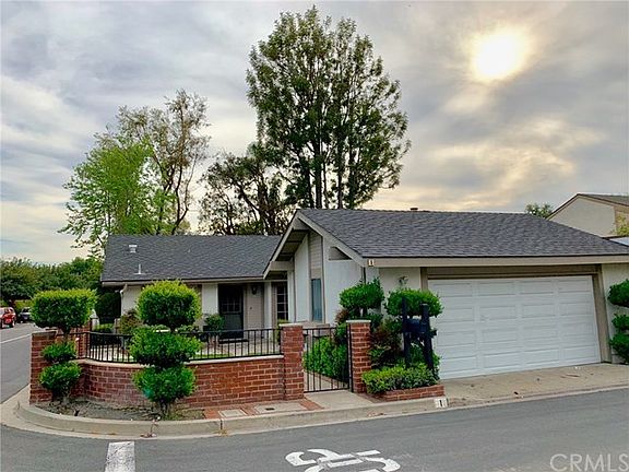 Two car detached garage has newer garage door.