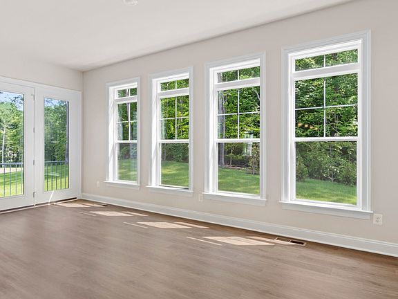 Morning room with wall of 4 windows and door to back yard