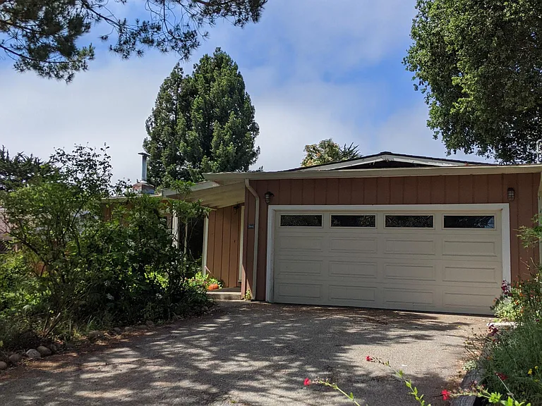 Home is on tree-lined street.