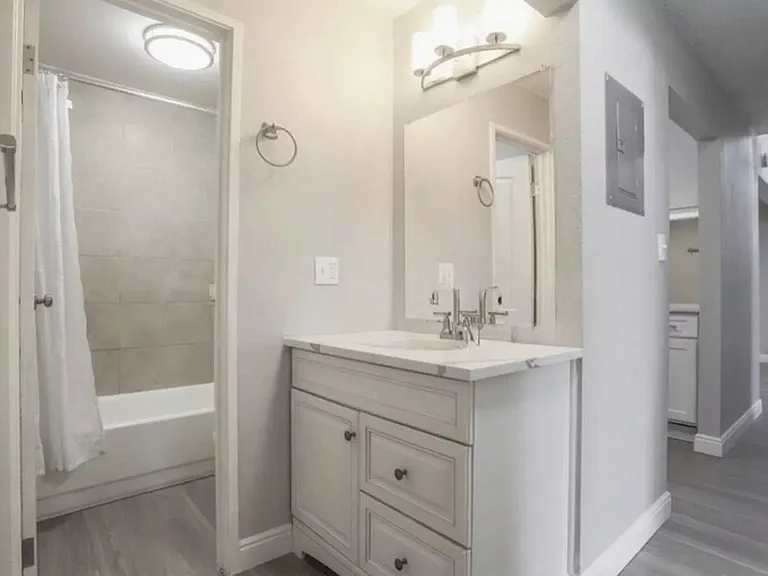 Bright and modern bathroom with sleek fixtures and spacious vanity, highlighting elegant design and style.