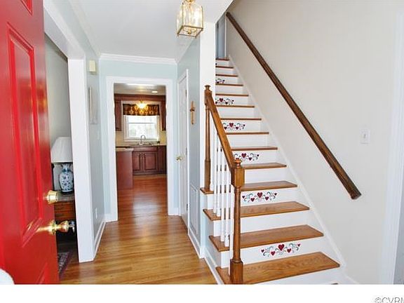 The Foyer Includes Hardwood Floors and Crown Moulding