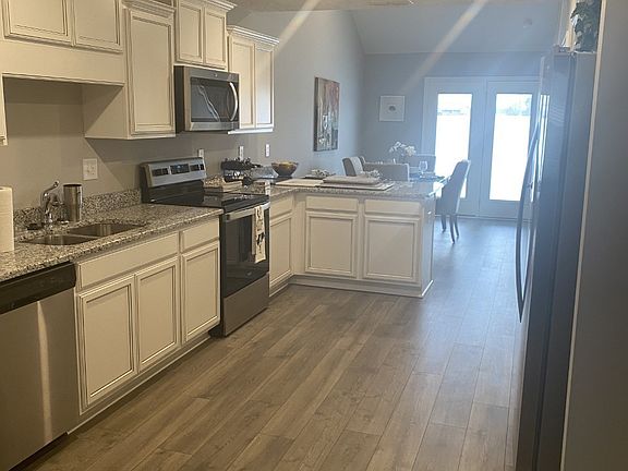 File Photo of Like Home Kitchen with Granite tops painted cabinets Stainless appliances