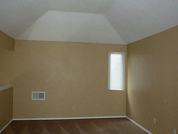 Second view of loft with high ceiling.