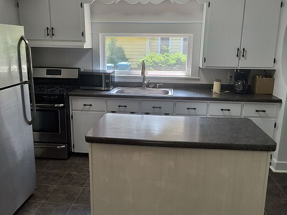 Kitchen with Island, large window over sink.