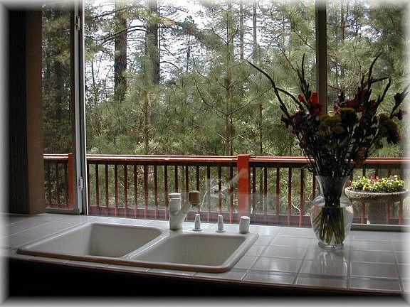 View out kitchen sink over deck, down to canal