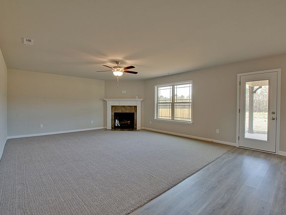 Large Empty Room with Fireplace in Premier Series 2143 from Hyde Homes