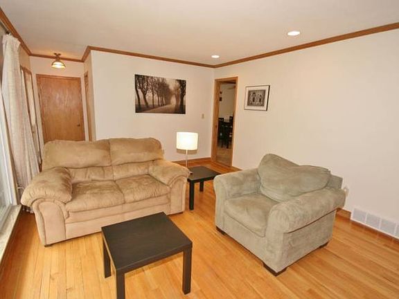 The living room makes a great space to entertain and dimmable can lighting adds a nice touch to the room.
