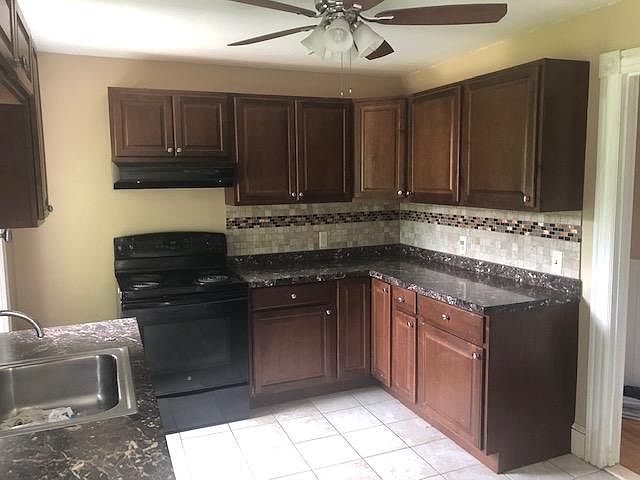 This is the old kitchen. The kitchen was renovated with wood cabinets, stainless steel sink and granite countertops.