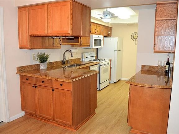 This wide open kitchen is full of upgrades.  Notice the garage door to the left just steps away.  The ceiling fan is added makin