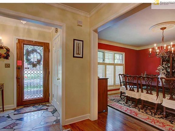 The entry shows off a taste of the detailed  crown molding and the gleaming hardwood floors.