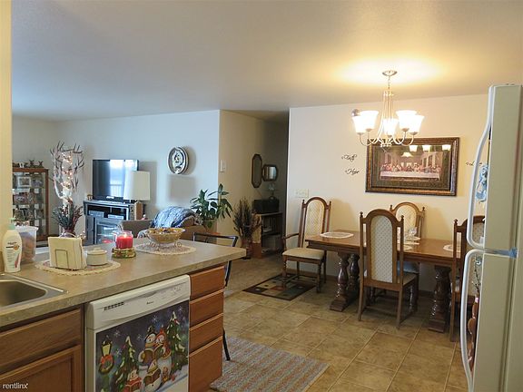 Standing in the kitchen looking into the hallway.