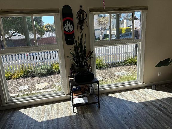Living room looking out to front. Top windows slide open for fresh air & to hear the ocean waves.