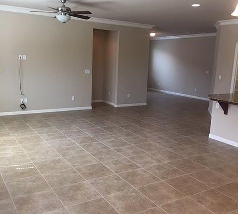 Tile flooring throughout (except bdrms). Crown molding in entry, den. living, dining and kitchen.