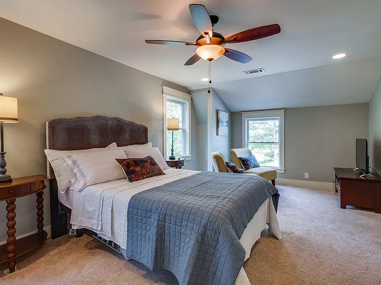The fourth bedroom includes a queen-sized bed and trundle bed with a sitting area.
